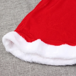 Detailed view of red velvet Christmas cloak with thick white faux fur trim and soft texture