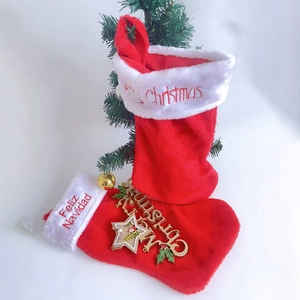 Classic red plush Christmas stockings with embroidered Merry Christmas and Feliz Navidad