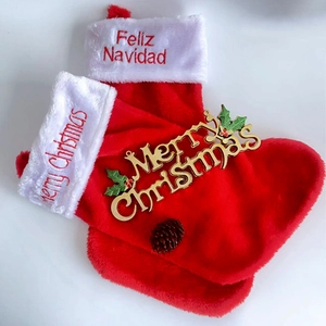 Pair of red Christmas stockings with white faux fur trim and gold decorative plate