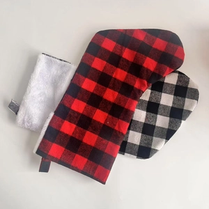 Detail of red and black buffalo plaid Christmas stockings with white faux fur trim