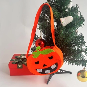Cute Halloween pumpkin treat bag made of orange felt fabric with a funny smiley face
