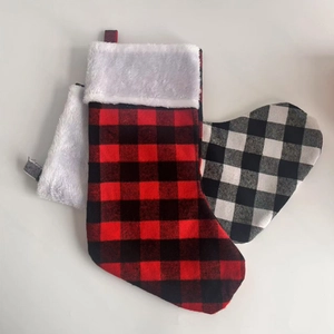 Close-up of red and black buffalo plaid Christmas stockings with plush faux fur trim detail