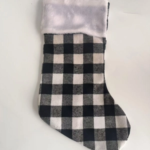 Classic black and white buffalo plaid Christmas stocking with white faux fur trim on top