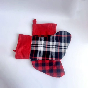 Set of two red and black buffalo plaid Christmas stockings with plush cuffs and hanging loops