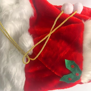 Plush Christmas gift bag with festive red and white faux fur and golden braided cord