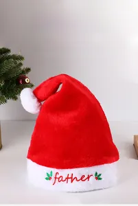 Detail of red plush Christmas hat with white fur trim and Father embroidery on the front