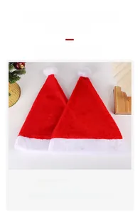 Detail of red plush Christmas hat with white faux fur cuff and embroidered father text
