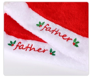 Detailed view of plush red Christmas hat with white 'father' embroidery and holly leaves