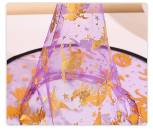 Detail of purple mesh Halloween witch hat with golden glitter pumpkin and bat patterns