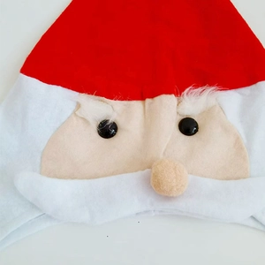 Classic red Santa Claus hat with plush white eyebrows and a decorative round nose