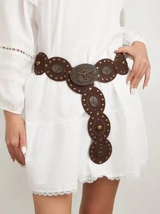 Detail of western retro leather belt with Texas Longhorn bull buckle and bronze rivets