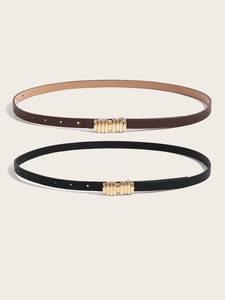 Detail of two minimalist PU leather thin belts in black and brown with golden metal buckles