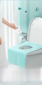 Detail of disposable toilet seat cover showing the long waterproof design and adhesive tapes