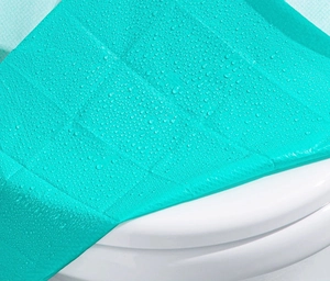 Macro detail of waterproof embossed surface showing hydrophobic water droplets on teal pad