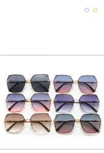 Close-up of square oversized sunglasses with gold metal H-logo hardware on temples