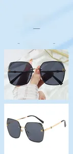 Detail view of gold square metal frame sunglasses with H-shaped hinge and grey lenses