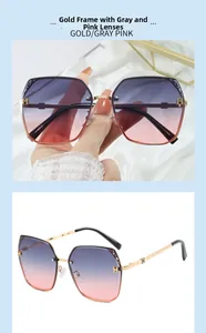 Detail of oversized gold metal hexagonal sunglasses with grey-pink gradient lenses