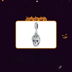Detail of S925 sterling silver skull charm with blue rhinestones for Halloween jewelry