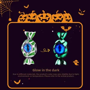 Macro detail of S925 silver candy charm with a glowing blue eyeball for Halloween