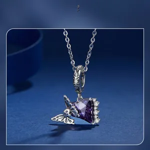 Detailed macro shot of gothic 925 silver necklace with purple heart stone and skull butterfly