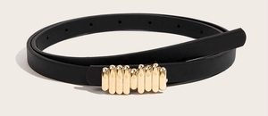 Detail of a thin black PU leather belt with a modern gold tubular buckle design