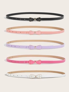Detail of five colorful children's skinny belts with golden bow buckles and patent finish