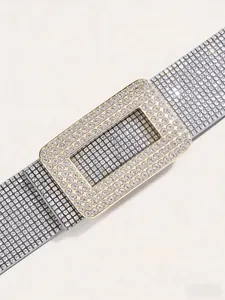 Detailed close-up of a sparkling rhinestone belt with a luxury gold crystal buckle
