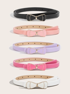 Detail of five colorful children's skinny belts with golden bow buckles and enamel inlay