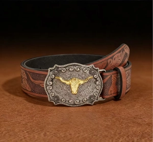 Detail of vintage Western leather belt featuring embossed floral patterns and bull buckle