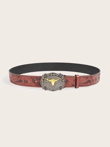 Detailed close-up of a western cowboy leather belt with floral embossing and a bull head buckle