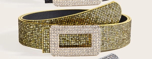 Macro view of gold sequin belt with a large sparkling rhinestone rectangular buckle