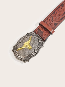 Close-up of vintage Western belt with bull head buckle and floral embossed leather strap