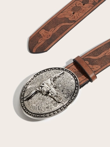 Close-up of embossed brown leather belt with ornate silver bull skull metal buckle