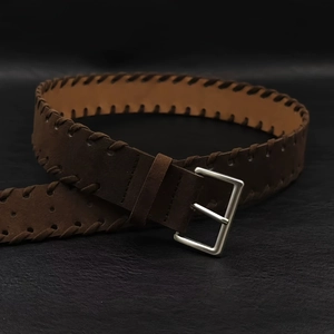 Vintage dark brown leather belt with woven edges and silver metal buckle for jeans