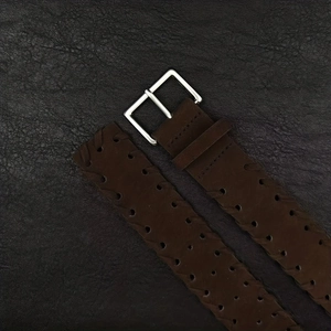 Close-up of dark brown leather belt featuring woven texture and silver square metal buckle