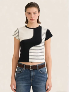 Detail view of a slim fit cropped T-shirt featuring black and white geometric color blocks