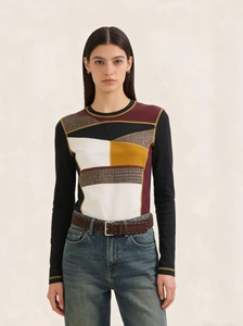 Close-up of a brown woven leather belt paired with high-waist blue denim jeans