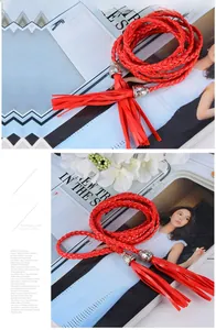 Close-up of red braided belt with decorative tassels and engraved silver metal caps