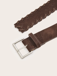 Close-up of brown suede belt featuring intricate edge weaving and silver metal buckle