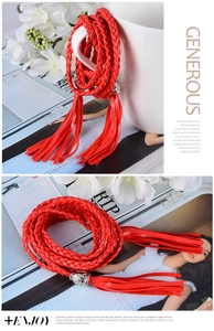 Detail of red braided waist rope featuring silver floral metal buckle and tassel ends