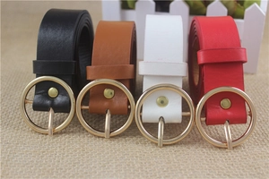 Detail view of round gold buckle belts in black, brown, white and red leather finish
