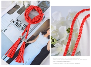 Detail view of red braided waist rope with silver metal buckle and elegant tassel