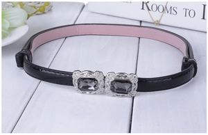 Détail de ceinture en similicuir aux couleurs acidulées avec boucles argentées et gemmes
