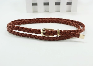Close-up of brown woven leather belt with a gold D-ring buckle and metal tip