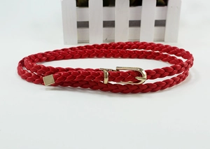 Detail of red braided belt with high-quality gold metal buckle and square metallic tip
