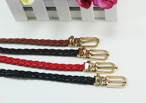 Close-up of four thin woven leather belts for women in brown, coffee, red and black