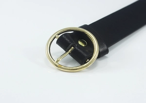 Close-up of classic black leather belt featuring a polished gold round metal buckle detail