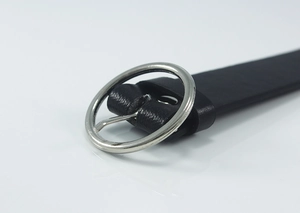 Close-up of black leather belt with a polished silver circular metal buckle detail