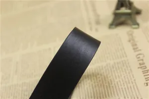 Detailed macro view of black leather belt featuring fine grain texture and smooth edges