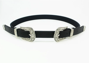Detail of black leather belt featuring dual silver buckles with Western floral carvings